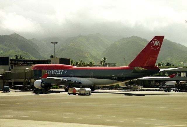 Boeing 747-400 (N661US) - PHNL- N661US 23719/696 delv new 08-12-1989 to Northwest Airlines. This one of the 1st 747 400 s delivered to NWA if not the 1st one built. Shown resting between flights at Honolulu in July 1998. Now taken up by Delta in the Delta/NWA merger. Our family had friends when we lived in Seattle in the 1960 s that were original B 377 Stratocruiser Pilots - I went to school with his son.