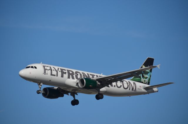 Airbus A320 (N221FR) - The frog arriving at ORD as seen from the rear lot of the Gate Gormet.