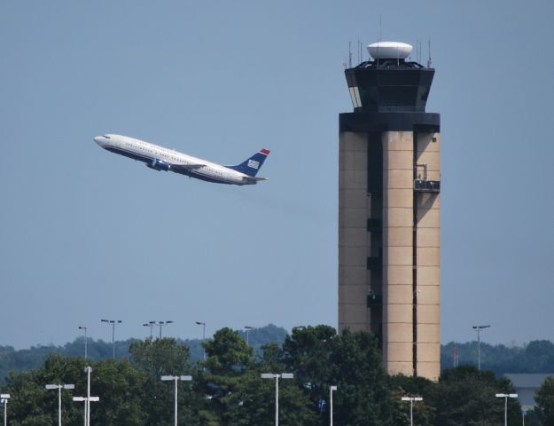 Cessna Citation Excel/XLS (KCLT) - ATC Tower with a US Airways 737 departing from runway 36R in the background - 9/2/10