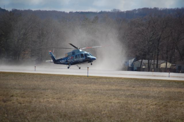 Sikorsky S-76 (N176BA) - N176BA clearing the dust off 28 during crosswind training