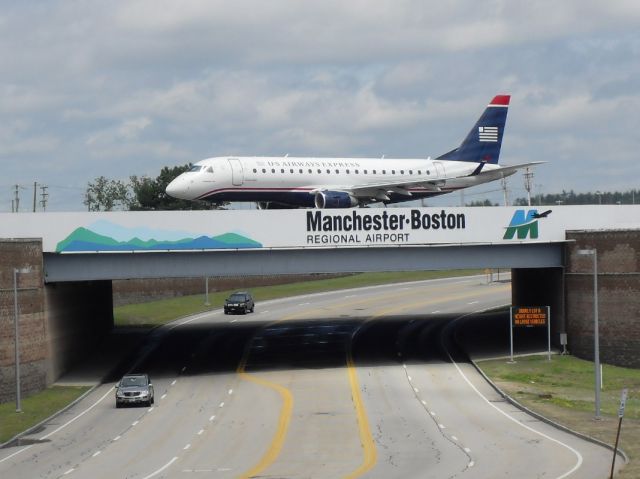 — — - US Airways crossing bridge over Airport Road, on Taxiway Mike at MHT - headed to Rwy4