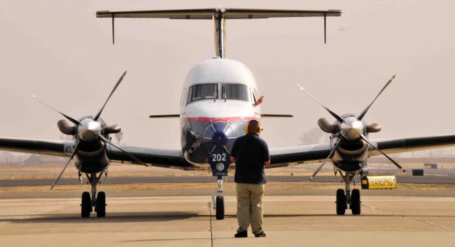 Beechcraft 1900 (N202UX) - START # 2! (note pilots hand poking out the aircraft window)