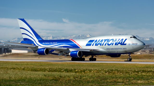 Boeing 747-400 (N952CA) - Left of the tunnel looking west at 35R in Calgary. This B747 took off at 11am.  Lucky to get the mountains in the background