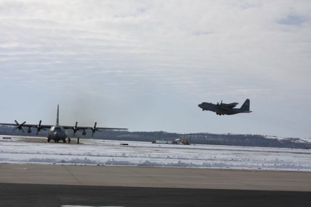 Lockheed C-130 Hercules (JETRACN) - This was taken at rosecrans Airport with a pair of C-130s the one on the ground is from Delaware Air Guard and the one taking off is from the St Joe Air Guard it was a cold but great day for catching the hurks