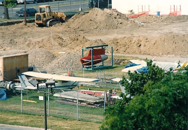 — — - Looking out our motel window at KLGA. Across the street was a school with these items in their lot. You can see a Cessna 150, a twin Comanche, the tail of another Cessna and a jet engine pylon from a P2V