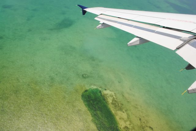 Airbus A320 — - Coral Reef under the wing of A320 departing Grand Cayman