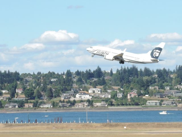 Boeing 737-700 (N626AS) - From Parking garage 7th level. Runway 28R. Panning shot.