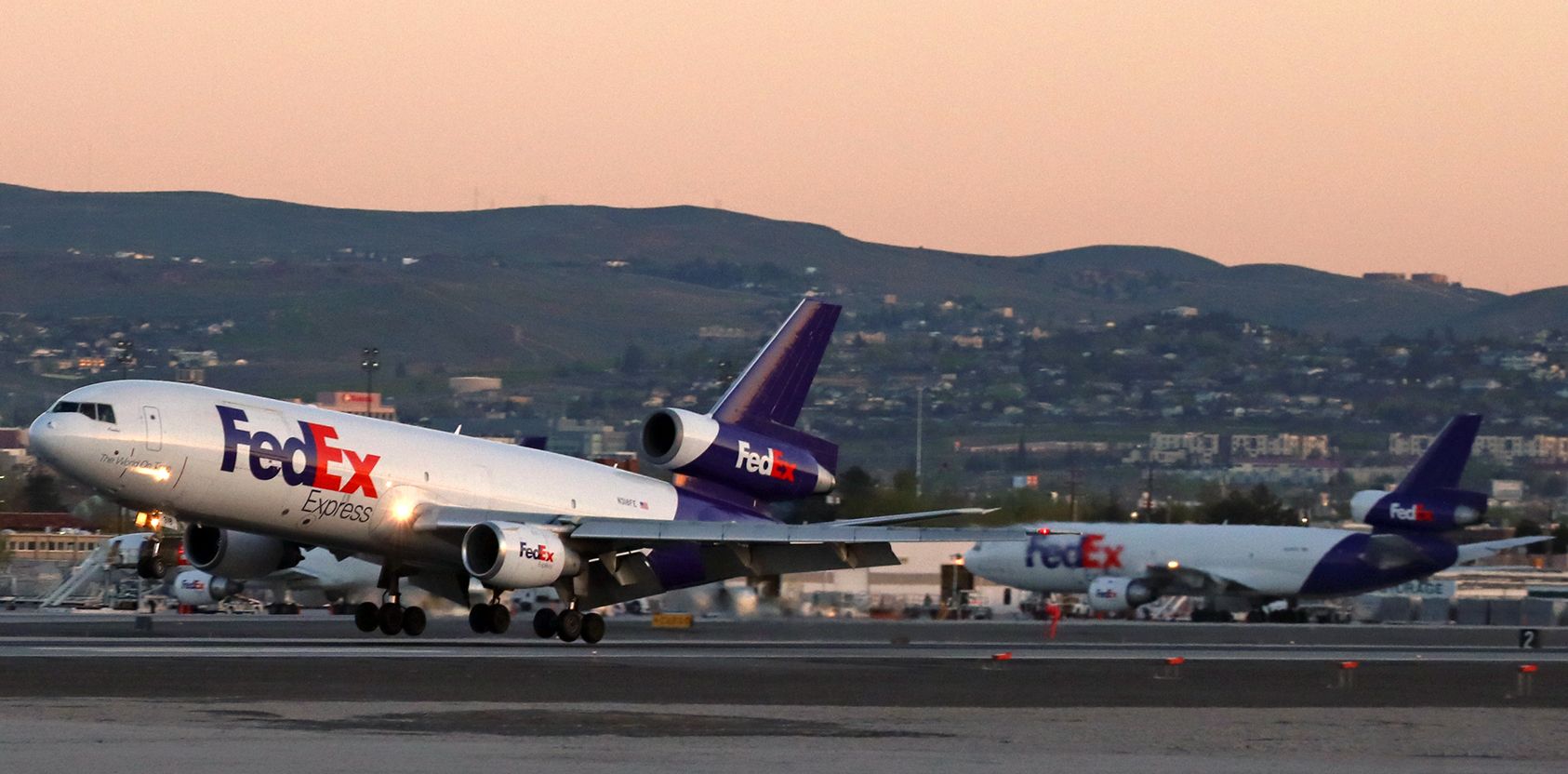 McDonnell Douglas DC-10 (N318FE) - Snapped less than two minutes earlier than the picture I posted yesterday, this click captures Annabel (N318FE) as it is touching down on runway 16R.  In this photo, the sun is still a whisker below the mountains behind me so the entire scene here is still in the last few seconds of dawn shadow.  By the time Annabel had stopped, turned off the runway, and started taxiing back toward the cargo ramp, the sun had started appearing and the scene was as shown in yesterdays picture.   Pretty amazing how quickly the sun rises.