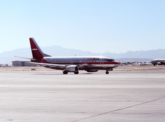 BOEING 737-300 (N394US) - KLAS - Predecessor airline US Air before name change to US Airways - this workhorse 737-300 taxis to the 10s for a departure to Philadelphia on a hot August 1988 afternoon.