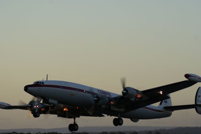 Lockheed EC-121 Constellation (VH-EAG) - Evening take-off from Avalon Australia. Rich fuel mixture providing exhaust flames