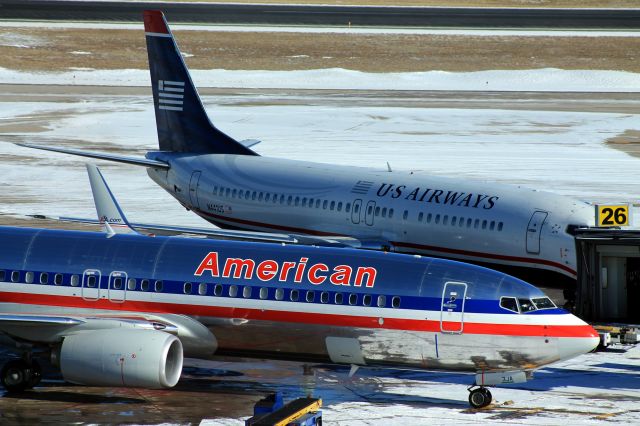 Boeing 737-800 (N891NN) - American parked at the gate with US Air parked at an adjacent gate.