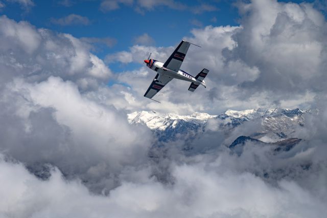 EXTRA EA-300 (N82AU) - In formation with the pilot banking to the right.br /br /This was shot over the Wasatch Mountains of Northern Utah from a Beechcraft 55 Baron