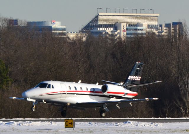 Cessna Citation Excel/XLS (N900KD) - WELLS FARGO BANK NORTHWEST NA TRUSTEE (NASCAR driver Kevin Harvick) arriving runaway 02 with the Charlotte Mortor Speedway in the background - 1/24/16