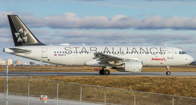 Airbus A320 (N689TA) - Holding short of 06L bound for El Salvador