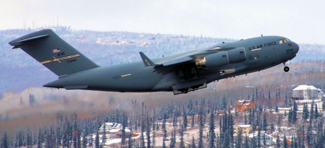 Boeing Globemaster III — - C-17 climbing out. Notice the background its a closeup of the hill in many of my photos on the pond.