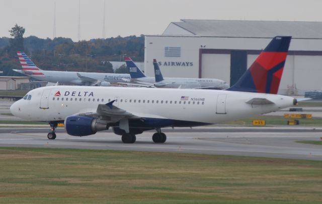 Airbus A319 (N366NB) - Taxiing across runway 18C - 10/29/14