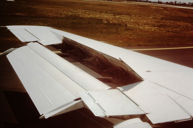 Boeing 727-100 (UNKNOWN) - Way back in January 1983, landing at Melbourne from Sydney.  Nice view of the TAA/Australian Airlines 727 wing in landing position with spoilers out. TAA/Australian Airlines is now part of Qantas. 