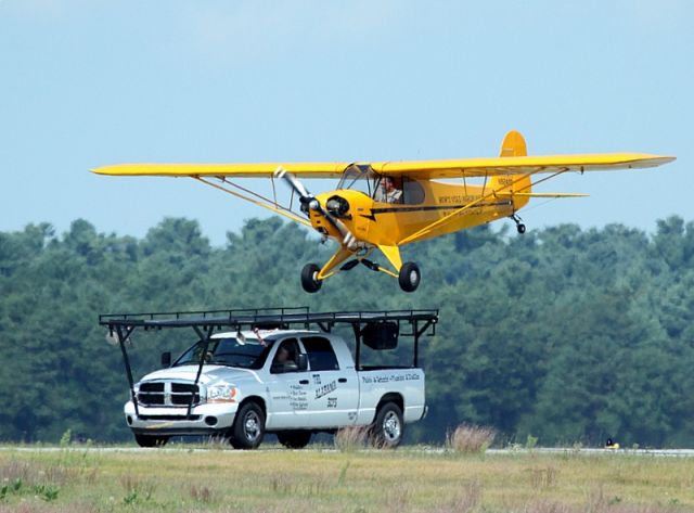 Piper NE Cub (N92400) - Greg Koontz 1946 Piper J-3 Cub landing on a moving truck platform.