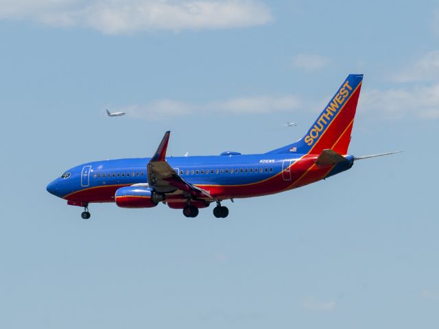 Boeing 737-700 (N216WR) - 7/10/2016 On final to 16L with 2 departures from 25 in the distance