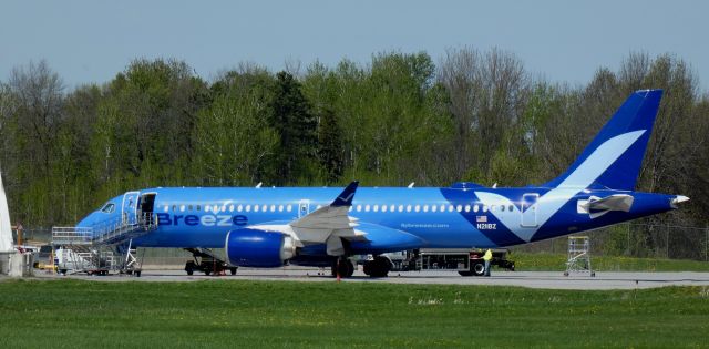 Airbus A220-300 (N211BZ) - Shortly after arriving is this 2022 Breeze Airways Airbus 220-300 in the Spring of 2025. KIAD - KOGS