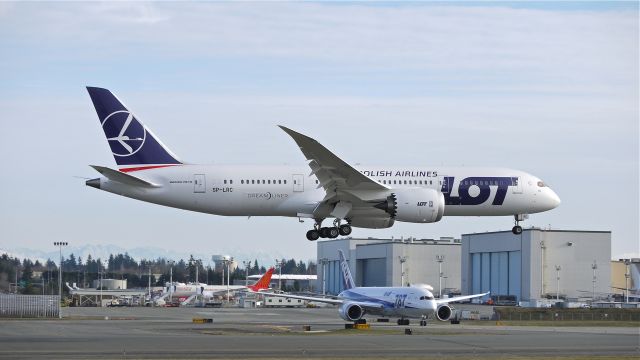 Boeing 787-8 (SP-LRC) - BOE272 on final approach to runway 16R to complete its maiden flight on 1/13/13. (LN:86 c/n 35940).  BOE512 #JA818A can be seen poised on Taxiway A1 for clearance to roll onto 16R.