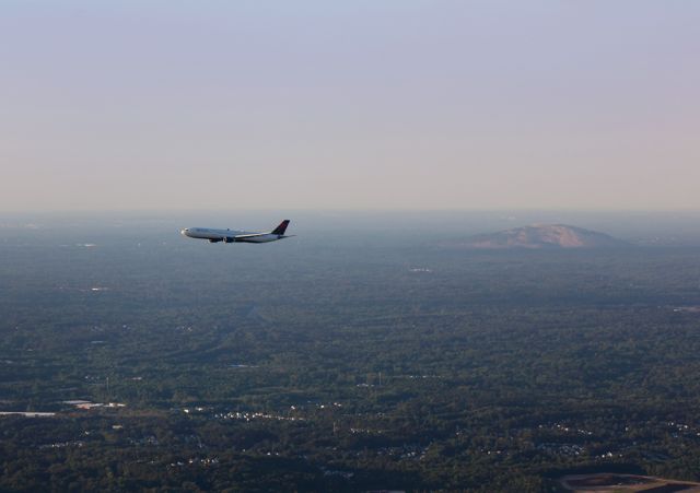 — — - Coming in on approach to Atlanta. Stone mountain in the background. Questions about this photo can be sent to Info@FlewShots.com