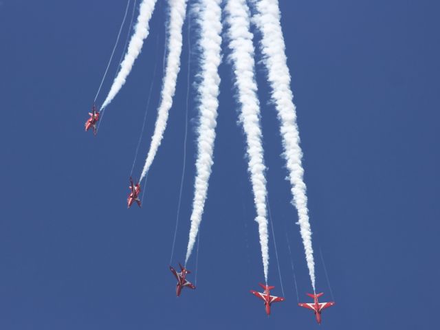 — — - The Red Arrows perform their routine at RIAT 2012, trailing some nice wing vortices on the way out of a loop.