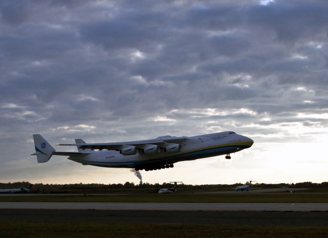 Antonov An-225 Mriya (UR-82060) - The big Antonov makes an evening takeoff on runway 36C at Charlotte, North Carolina USA. The world stopped while everyone who could came out to witness the takeoff this huge aircraft. We collectively held our breath and when it rotated everyone was cheerful and happy and talking to each other about their mutual experience of a historic moment. Then abruptly, it was business as usual. After a short pause while any wake turbulence dissipated, a commuter jet blasted off and it was back to work for people who can still dream.