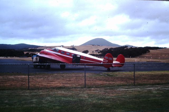 Beechcraft 18 (VH-FIE) - One of two Beech 18,s operated by Flinders Island Airlines loading crayfish for Melbourne, circa 1975