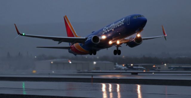 Boeing 737-800 (N8606C) - Southwest's N8606C is just off 35R and on the climb through a steady downpour in this breakfast hour snap.br /It had been raining all night and was supposed to continue raining all day BUT ... two hours after I got this shot the temperature dropped below freezing and the rain changed to snow. Initially, I was rather pleased that the precipitation had gone from rain to snow because my goal had been to get inclement weather photos (we don't get much rain OR snow at RNO so getting both in one visit was sort of a double dividend). However, the change in precip backfired on me. The snow became a blizzard rather quickly and by the 11 AM hour inbound flights were diverting and other scheduled flights were being cancelled due to visibility dropping below minimums. [In fact, a scheduled return visit in the afternoon by the above SW B738 (N8606C) was one of the many cancellations caused by the snowstorm.] By noon, with no commercial air traffic arriving anymore, there was little reason for me to stick around so I called it a day. But I did get what I went for -- inclement WX pictures.