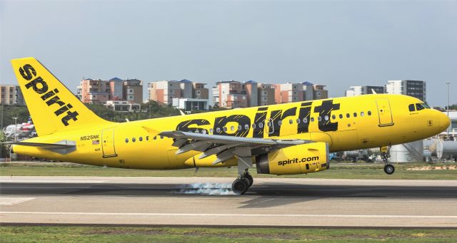 Airbus A319 (N525NK) - Spirit airlines smoking both main gears while landing at St Maarten.