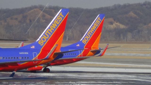 Boeing 737-700 (N237WN) - Tail and tail.  Southwest 2219 from Phoenix (the background aircraft) goes to gate B16.