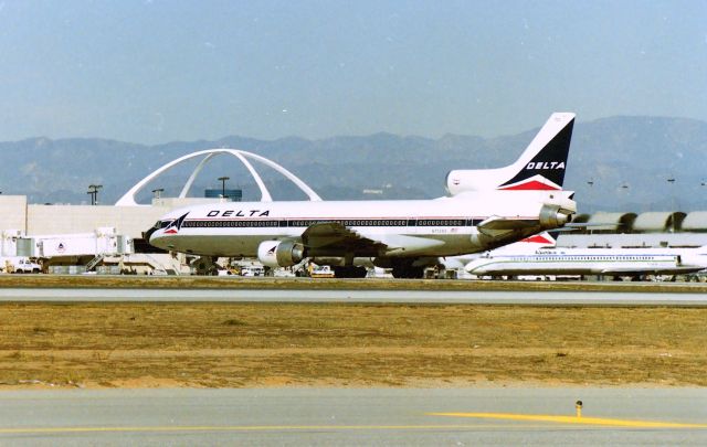 Lockheed L-1011 TriStar (N733DS) - KLAX - Delta L-1011 rolling of 25L after landing at Los Angeles - photo from the Imperial Terminal lot. Apprx date of this dusty negative March 1990!