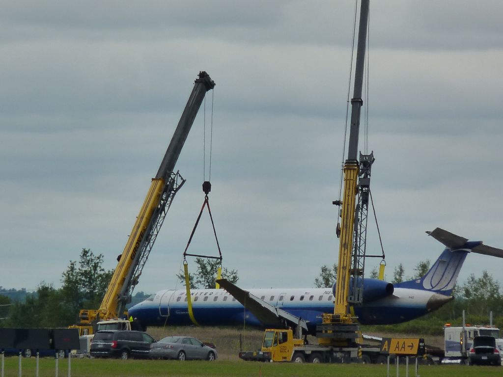Embraer ERJ-145 — - being hoisted by two cranes after yesterdays crash.