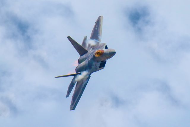 Lockheed F-22 Raptor — - This FF22 Raptor was performing a high speed banking turn over the crowd at the 2021 Sun N Fun aerospace expo in Lakeland Florida. I thought is was really cool to see the afterburner flames on an approaching aircraft, which isn't easy to see. I shot this with my Canon 600mm lens with the shutter cranked at 1/8000 second, F5.6, ISO 640. Please check out my other aviation photography. Votes and positive comments are always appreciated. Questions about this photo can be sent to Info@FlewShots.com