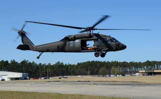 8724648 — - Carrying members of the Golden Knights for practice jump.  3-24-2017