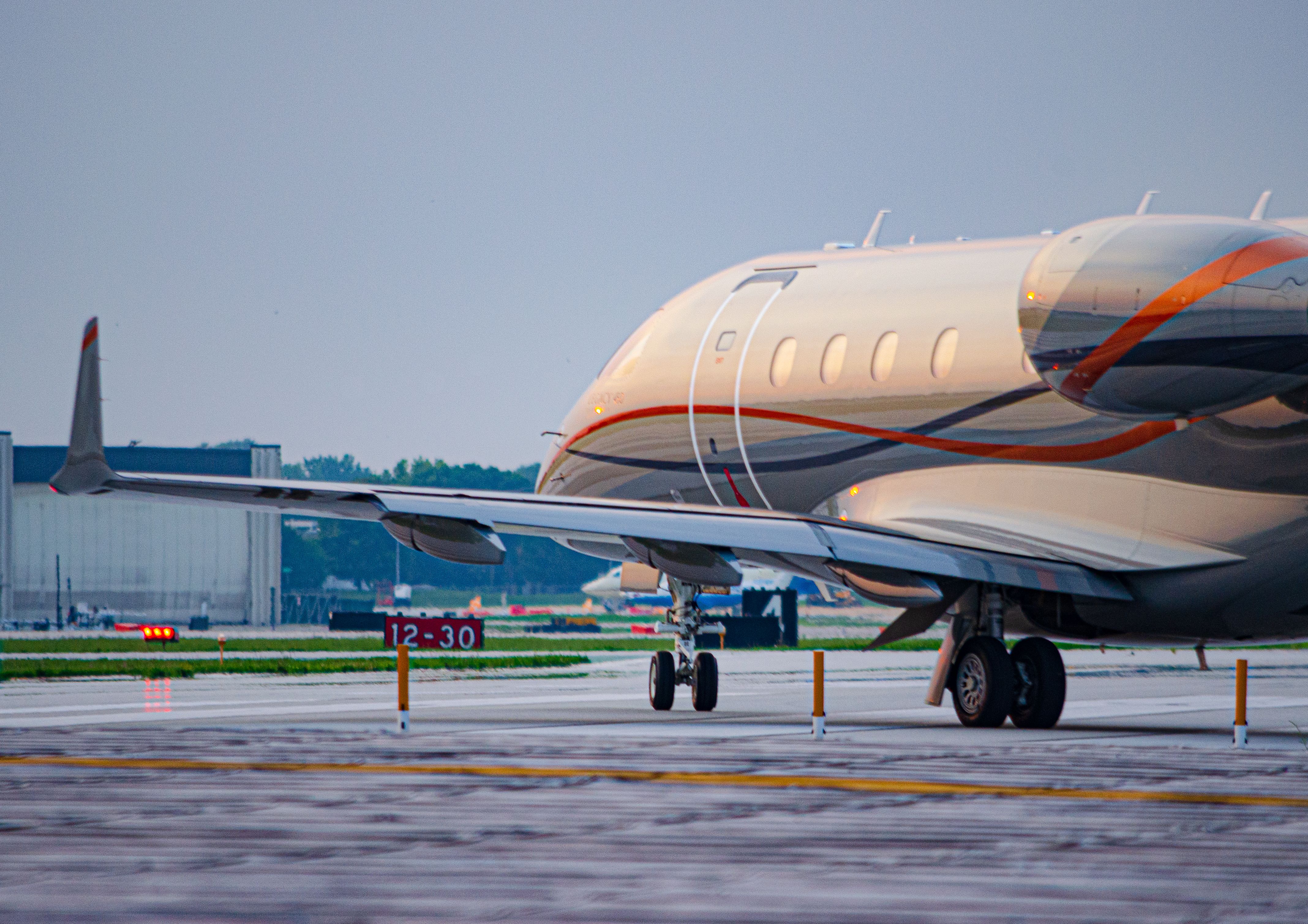 Embraer Legacy 450 (N747DP) - Standing at the end of the Runway watching a Embraer Legacy 450 departing off of Runway 34.