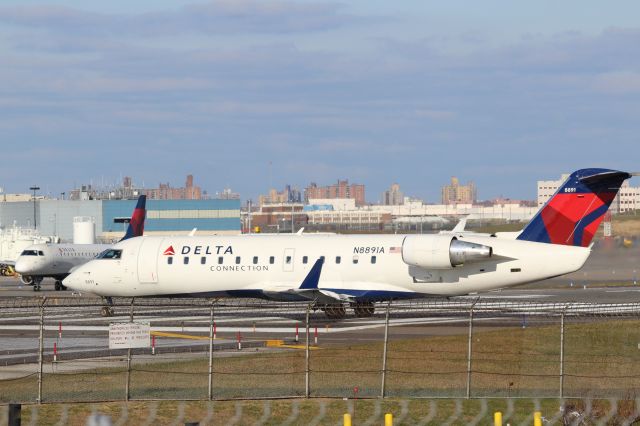 Canadair Regional Jet CRJ-200 (N8891A) - New York LaGuardia (LGA). Delta Connection/ Endeavor Air flight DL/9E5875 taxis for departure from Runway 22.br /Taken from Planeview Park, 23rd Avenue at the end of Runway 4/22br /2017 12 01  a rel=nofollow href=http://alphayankee.smugmug.com/https://alphayankee.smugmug.com//a