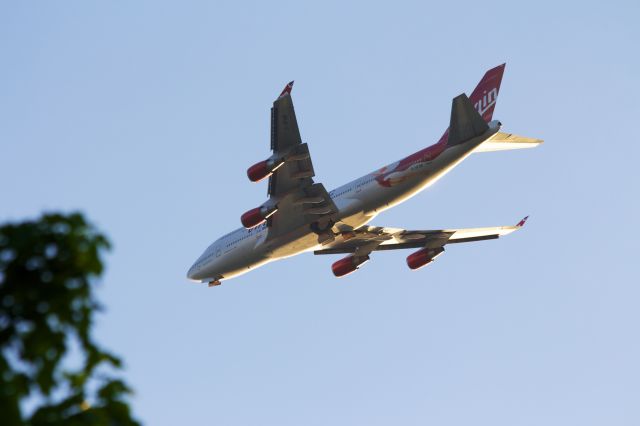 Boeing 747-400 (G-VFAB) - Over Long Island, final approach to runway 21L.  Near Sunset.  Landing gear doors just opening.