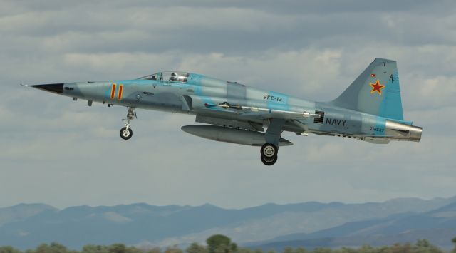 76-1537 — - The clouds were heavy and dark, but there was no rain falling when this VFC-13 "Saints" F5N aggressor returned from a TOPGUN training exercise and landed on NAS Fallons runway 31R.