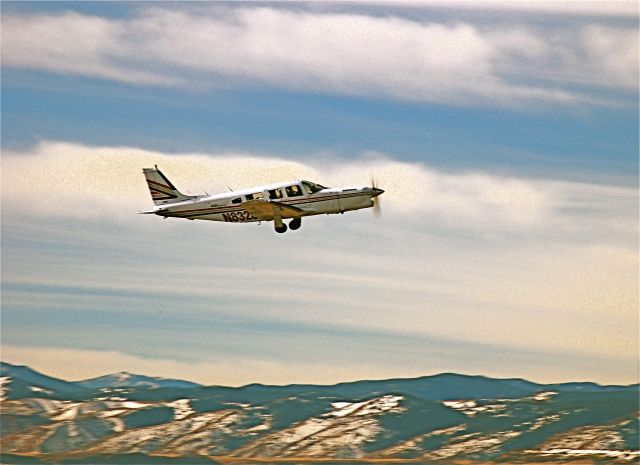 Piper Saratoga/Lance (N8328D) - Gear coming up while departing Jeffco CO.  Rockies in background