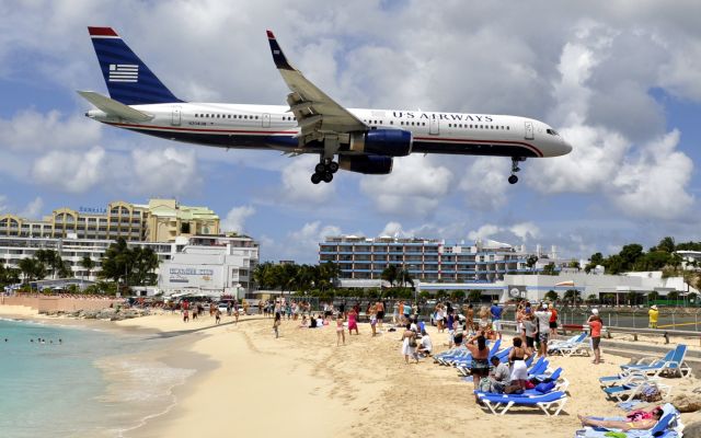 Boeing 757-200 (N204UW) - Flight from Charlotte (CLT) arrives at Princess Juliana Airport (SXM) in St. Martin on March 15, 2012.  Shot taken from the deck of the Sunset Bar and Grill at Maho Beach.