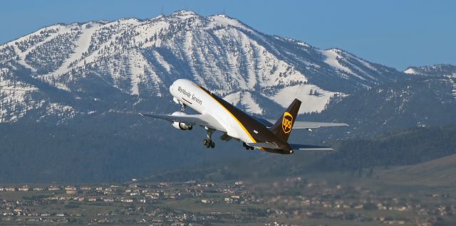 Boeing 757-200 (N408UP) - The sun had popped up over the crest of the Virginia Range Mountains behind my position and was lighting up Mt. Rose in the Sierra Nevada as well as the suburban area southwest of downtown Reno when UPSs N408UP, a B757-200, departed RTIA and climbed out from runway 16R to begin a flight to Des Moines (KDSM), IA.