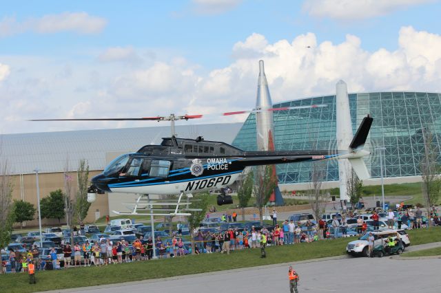 Bell JetRanger (N106PD) - 053114 SASM Chopper day, Omaha PD Able 1 landing. The speck above the museum is NSP on the inbound pattern.