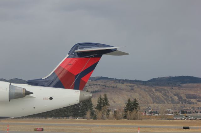 Canadair Regional Jet CRJ-700 (N713EV) - N713EV at Butte after landing from KSLC as SKYWEST 4312. Engines just turned off, with the APU on with the Berkeley Pit behind it.br /br /Taken 17:04, November 2, 2024 with a Canon EOS T2i and 70-300mm (115mm, 1/200, ƒ4.5, ISO 100)