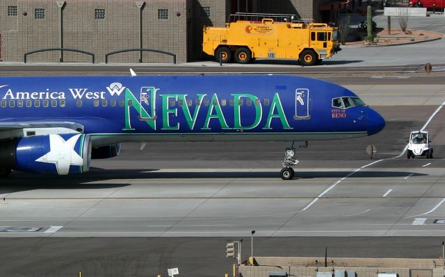 Boeing 757-200 (N915AW) - KPHX - Mar 21, 2007 - America West 757 with the "City of Reno" titles proudly displayed on the nose along with a little Ramp ant - that must have been quite the view as that 757 rolls by. Photo posting special request for the "Gman - Gary Schenauer.