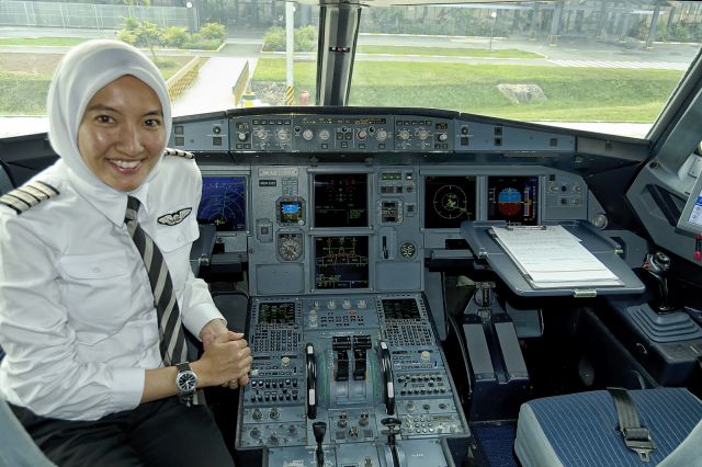 Airbus A320 (9M-AHE) - 21st Dec., 2014: Captain Nur Ishak poses for a shot after flying us in to Siem Reap from Kuala Lumpur (KLIA2).  According to her wrist watch, its 9:00am in KL ... which is 8am here in the home of Ankor Wat. (See a rel=nofollow href=http://www.airasia.com/travel3sixty/from-the-magazine/highlights/pilotsperspective/women-on-tophttp://www.airasia.com/travel3sixty/from-the-magazine/highlights/pilotsperspective/women-on-top/a)