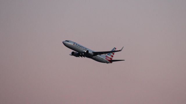 Boeing 737-800 (N878NN) - An evening departure from DFW as seen from Founder's Plaza. Not a lot of light to work with!