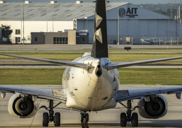 Boeing 737-700 (N13720) - Star Alliance waives goodbye with a rudder check as it begins to taxi for departurebr /7/1/17