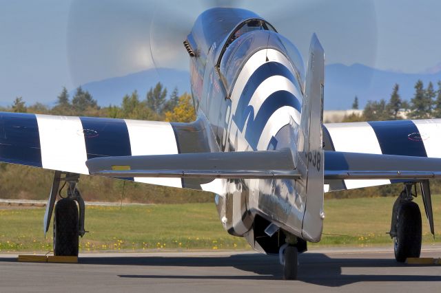 — — - North American P-51B "Impatient Virgin" with HFF founder John Sessions doing some pre flight.  Paine Field, Everett, WA. Canon 5DMkII W/300mm lens and slow shutter.